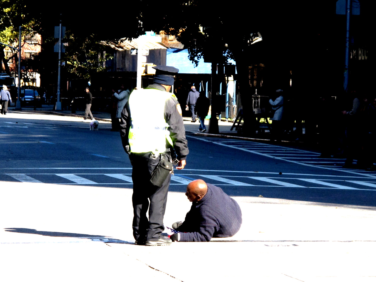 2  of 3 The man is checked to see if he is ok by the cop.