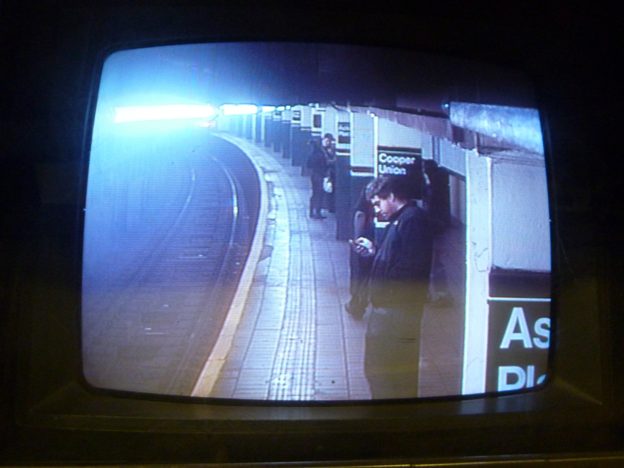 MODERN MAN STANDING ON PLATFORM WAITING FOR UNDERGROUND ELECTRIC TRAIN NYC 2010