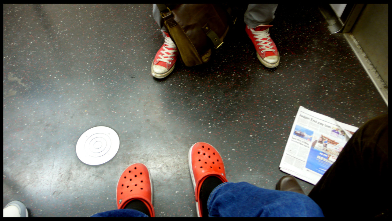 SELF PORTRAIT WEARING CROCS AND BLACK SOCKS