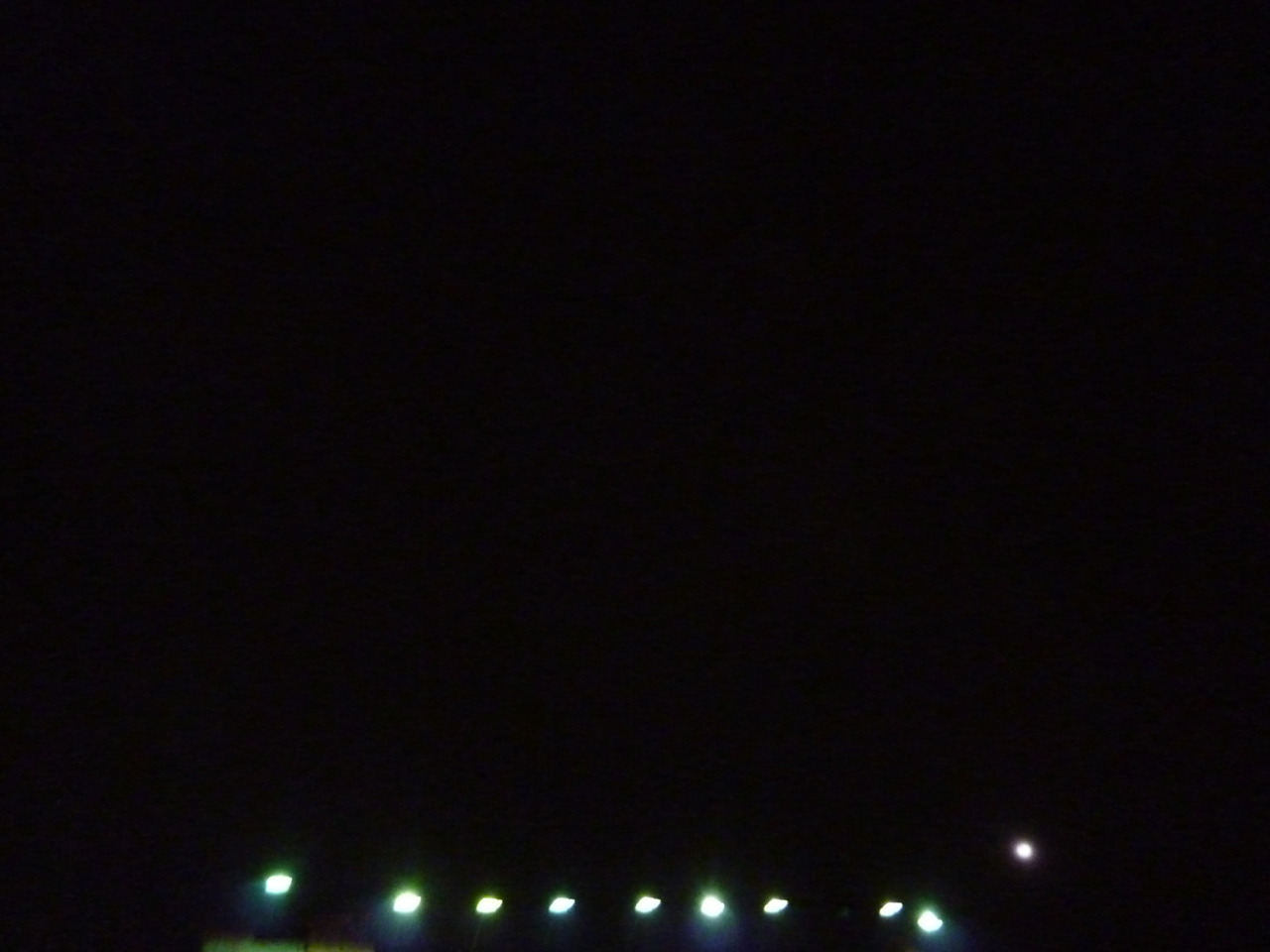 THE LIGHT A LITTLE BIT HIGHER THAN THE OTHERS ON THE RIGHT IS THE MOON