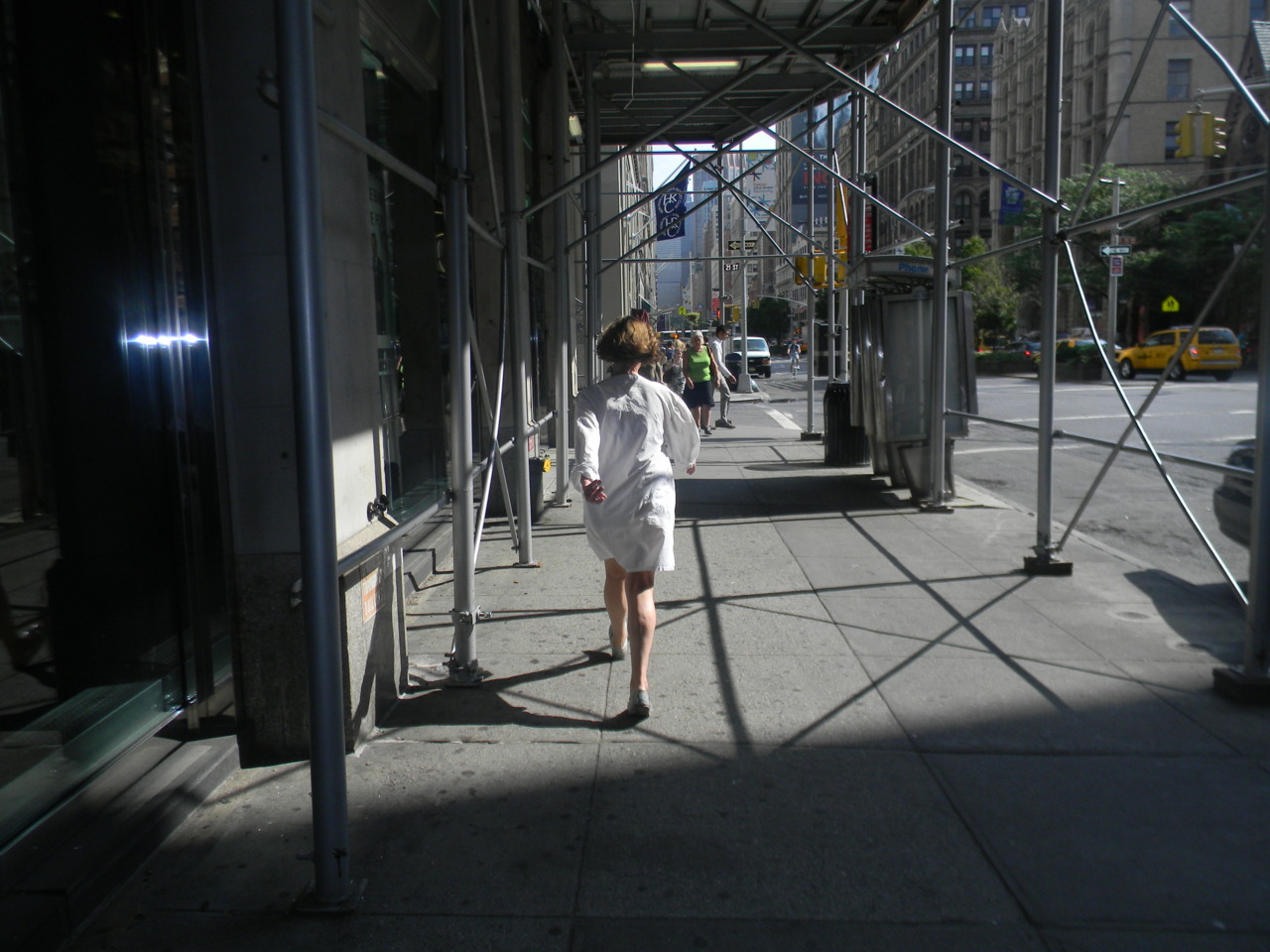 Woman power walking, destination or point of origin unknown. _NYC 2011